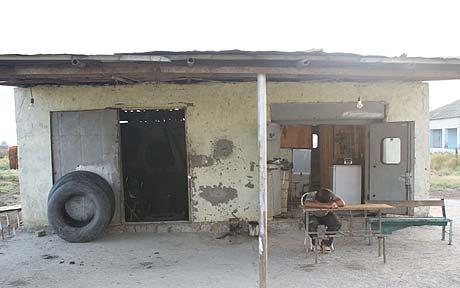 Shahin asleep outside his workshop - the bicycle diaries